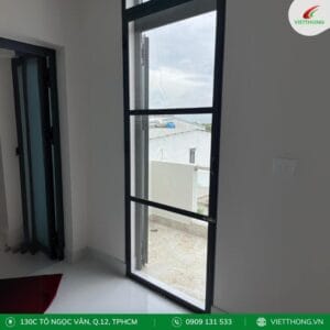Cửa lưới dạng cánh mở màu xám lắp cho khu vực ban công